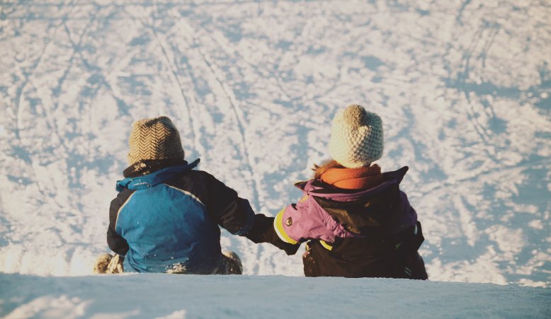 sledding holding hands